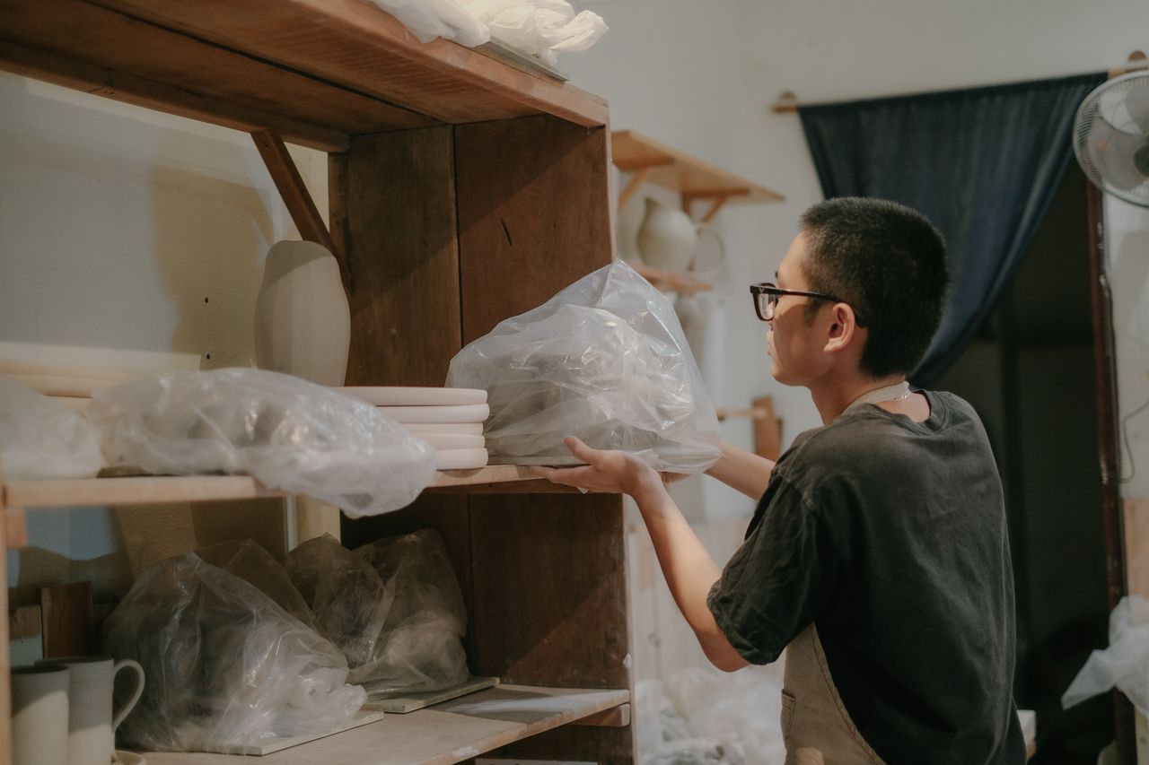 Shelves of handmade pottery in our studio